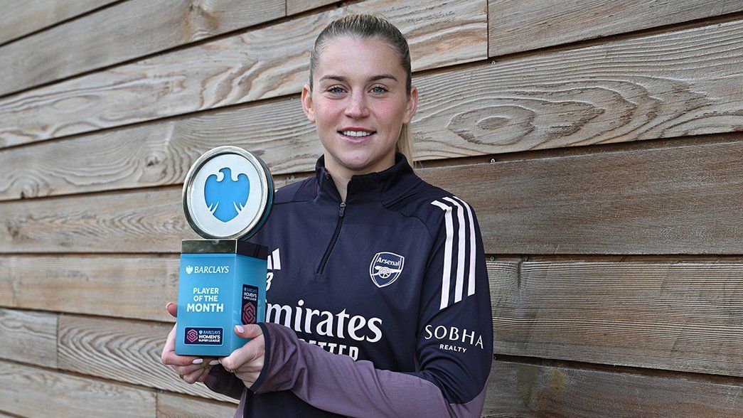 Alessia Russo holds the WSL Player of the Month trophy